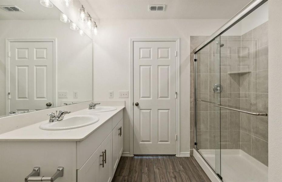 Spacious owner's bathroom with dual vanity *real home pictured