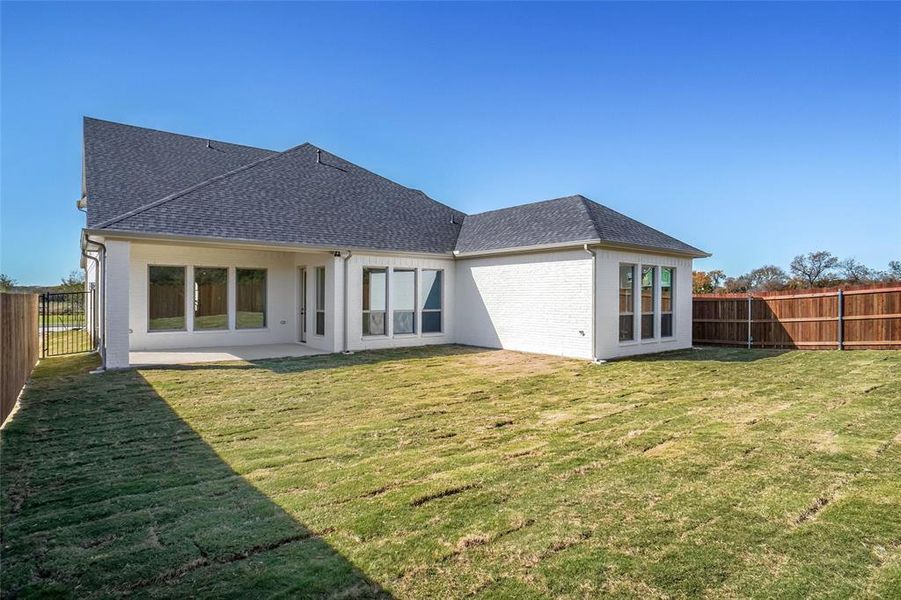 Rear view of house with a lawn