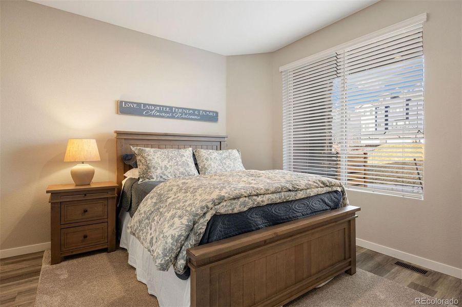 Lower level bedroom with a large window and en suite bathroom.
