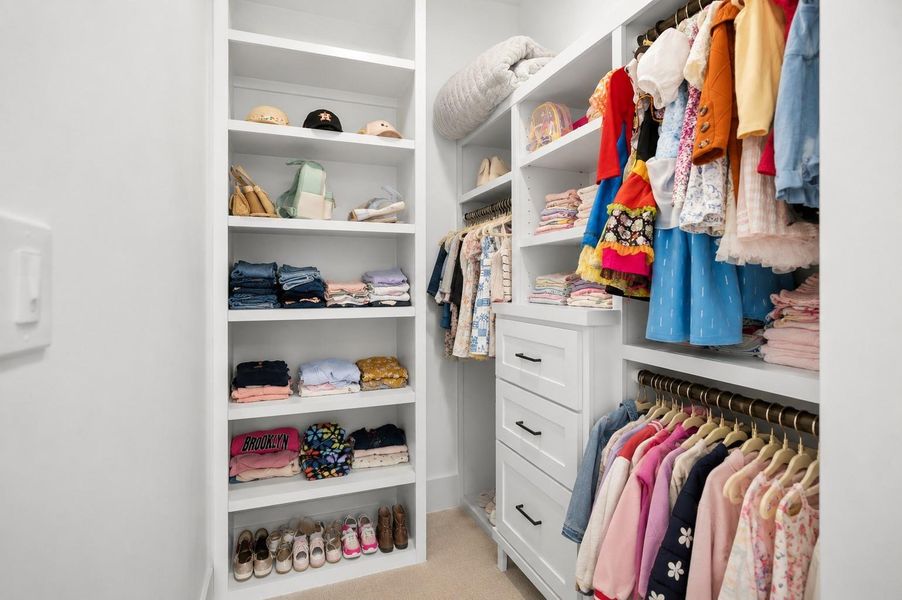Spacious secondary bedroom with walk-in closet and private ensuite bathroom.