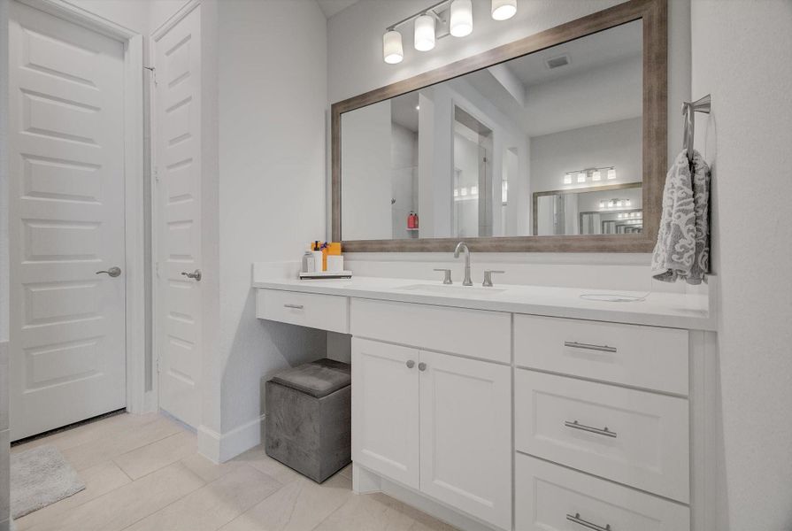 His private vanity area offers a comfortable seated vanity and upgraded soft-close cabinets and drawers for refined everyday use.