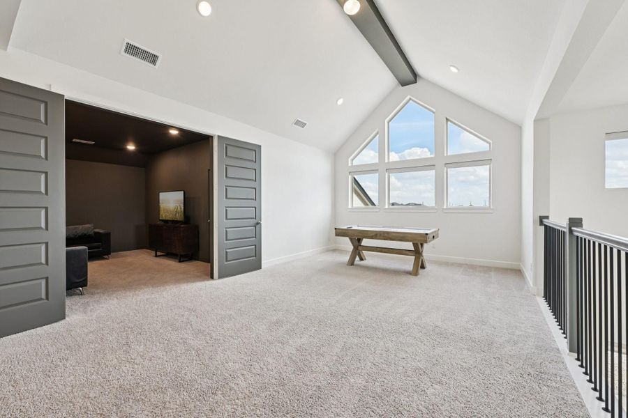 Vaulted ceiling in game room - windows overlook back with water view