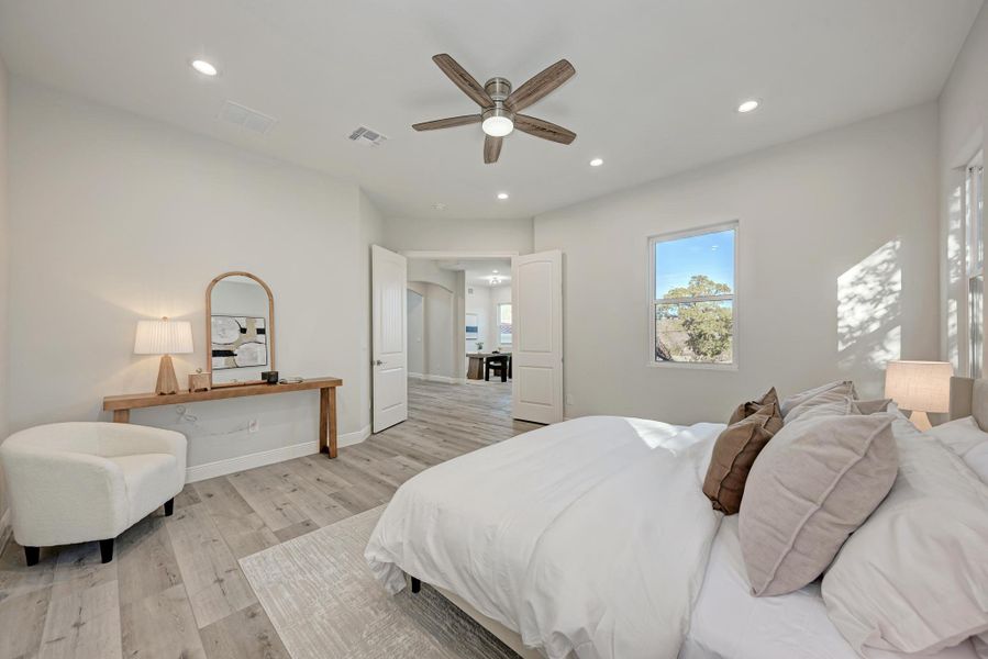 Bedroom with light wood-type flooring, ceiling fan, and recessed lighting