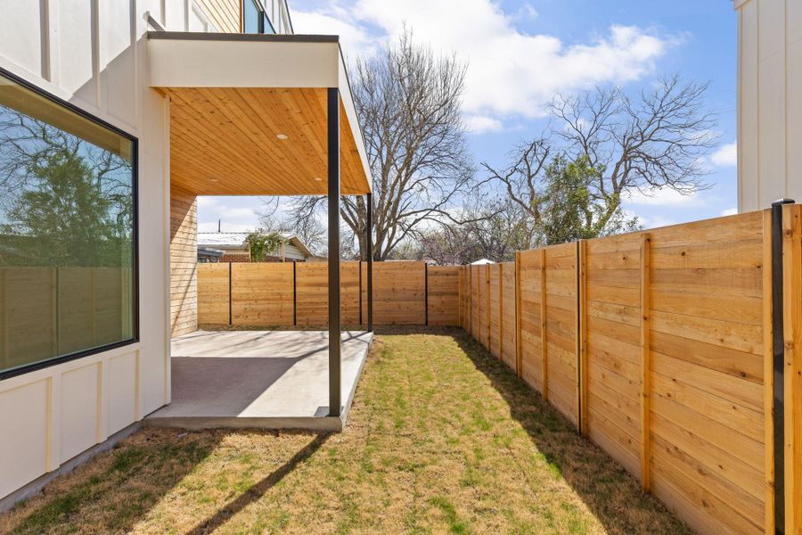 View of yard with a fenced backyard and a patio