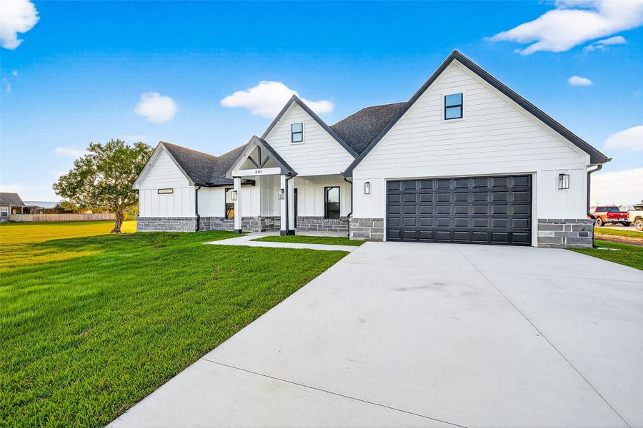 Front exterior of a new home in , Angleton, TX, highlighting curb appeal (Image 1). Front exterior of a new home in , Angleton, TX, highlighting curb appeal (Image 1).