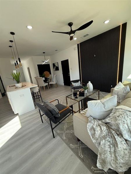 Living room featuring Luxury plank vinyl/ wood-style floors and ceiling fan