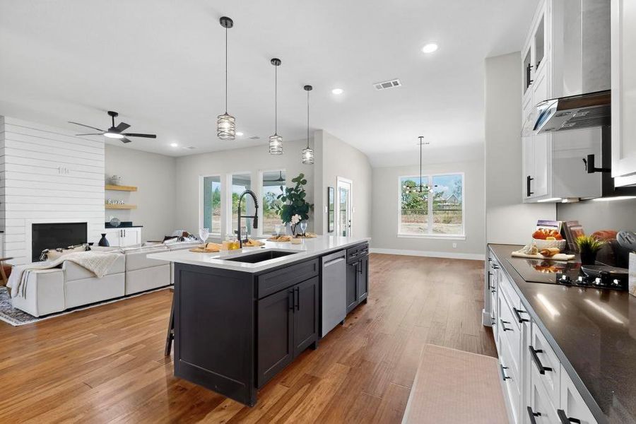 Kitchen with stainless steel dishwasher, white cabinetry, light wood-type flooring, ceiling fan, and recessed lighting