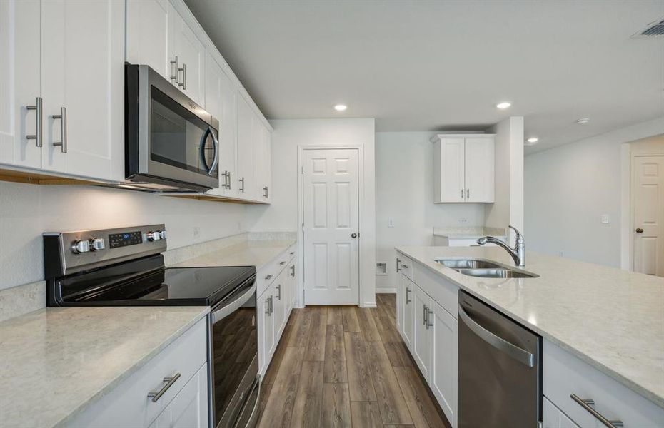 Airy kitchen with oversized island*real home pictured