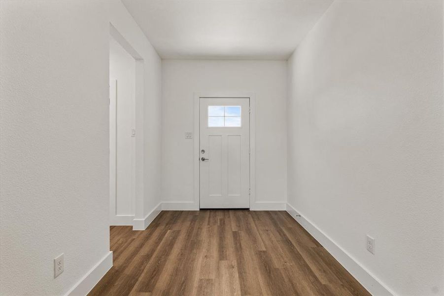 Entryway with dark hardwood / wood-style flooring