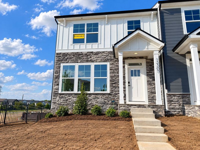 Front exterior of a new home in Bryton Crossing Townhomes, Huntersville, NC, highlighting curb appeal (Image 1). Front exterior of a new home in Bryton Crossing Townhomes, Huntersville, NC, highlighting curb appeal (Image 1).