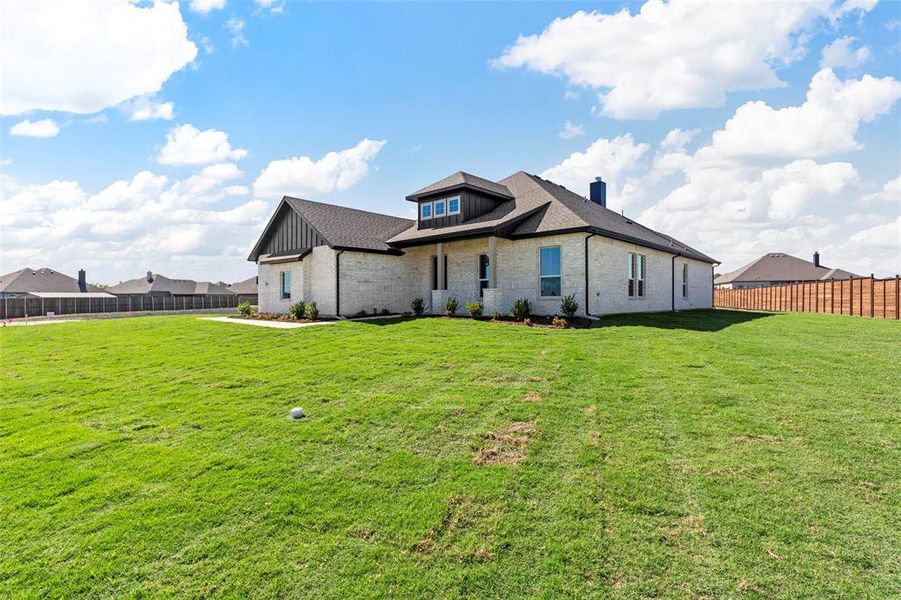 Rear view of property featuring a lawn