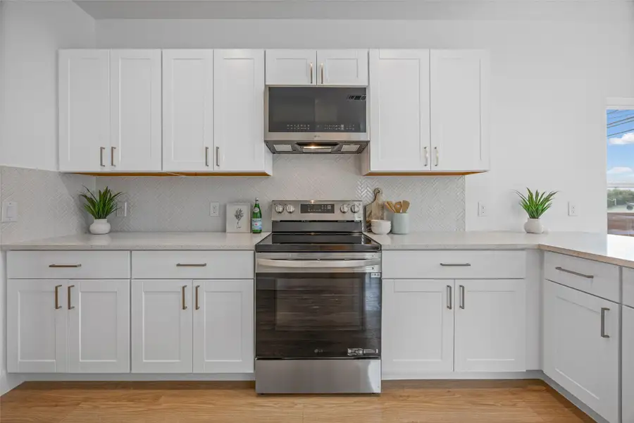 A well-equipped kitchen showcasing modern stainless steel appliances and crisp white cabinetry. A well-equipped kitchen showcasing modern stainless steel appliances and crisp white cabinetry.