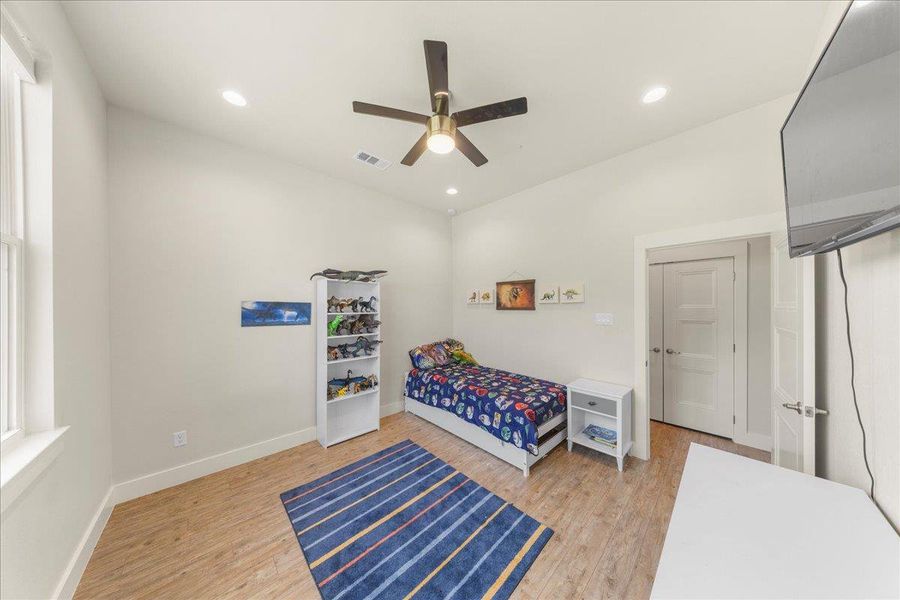 Bedroom featuring light wood-style flooring, recessed lighting, and a ceiling fan Bedroom featuring light wood-style flooring, recessed lighting, and a ceiling fan
