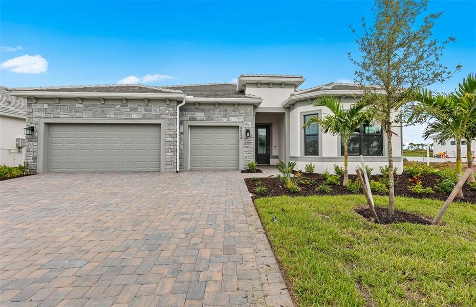 Front exterior of a new home in Del Webb Catalina, Lakewood Ranch, FL, highlighting curb appeal (Image 2).