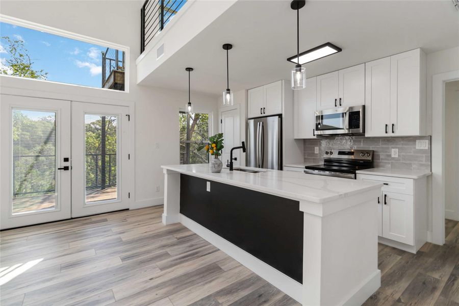 Pendant lighting over quartz center island Pendant lighting over quartz center island