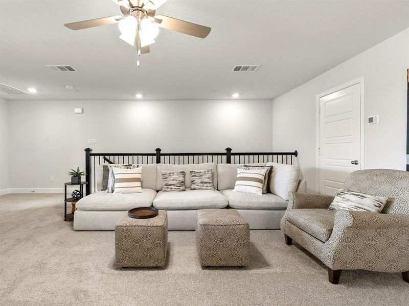 The game room features smooth indoor-outdoor flow with a direct walk-out door to the top-floor private covered patio/balcony.