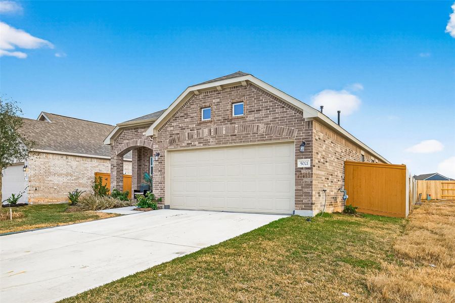 Front exterior of a new home in Sunterra, Katy, TX, highlighting curb appeal (Image 23).
