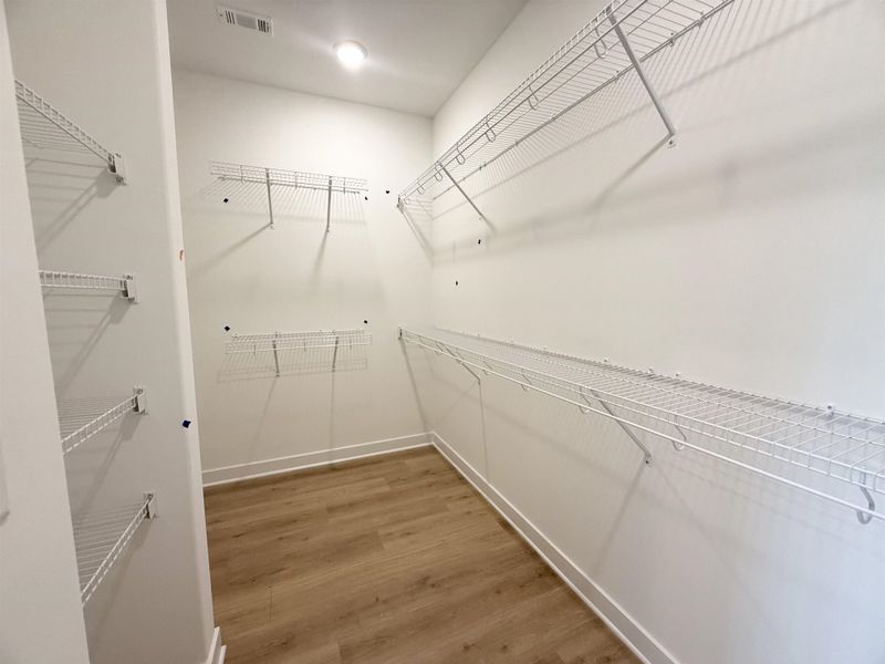 Spacious closet featuring light wood-type flooring Spacious closet featuring light wood-type flooring