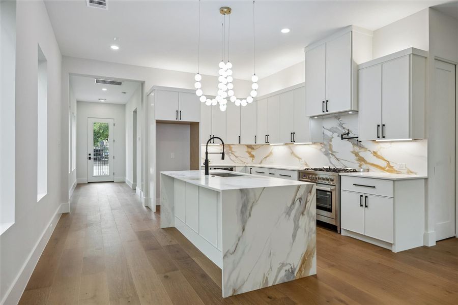 The kitchen was designed to feel open without losing functionality or storage. Views into the surrounding living spaces help the entire first floor feel connected. The kitchen was designed to feel open without losing functionality or storage. Views into the surrounding living spaces help the entire first floor feel connected.