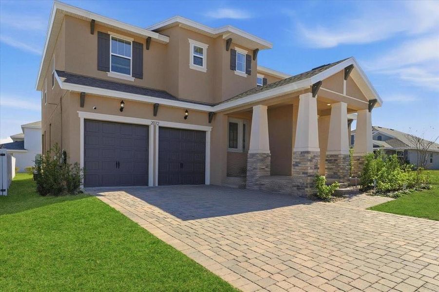 Front exterior of a new home in Hills of Minneola, Minneola, FL, highlighting curb appeal (Image 31).
