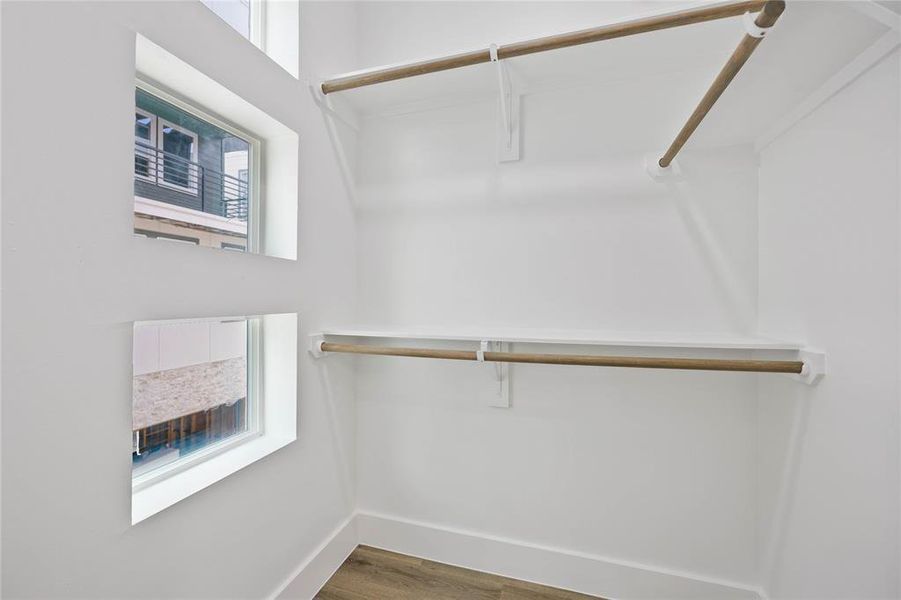 The bedroom includes an oversized walk-in closet with windows to bring in light.