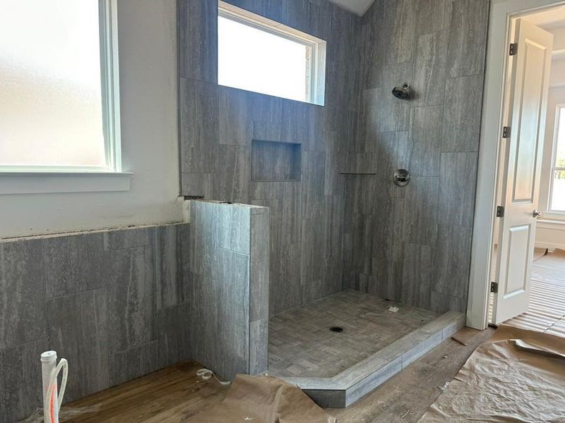 Full bathroom featuring a walk in shower and wood finished floors