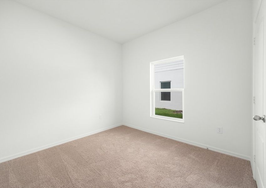 Third bedroom with lush carpet flooring