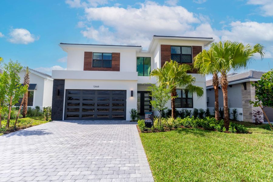 Front exterior of a new home in Solana Bay at Avenir, Palm Beach Gardens, FL, highlighting curb appeal (Image 1).