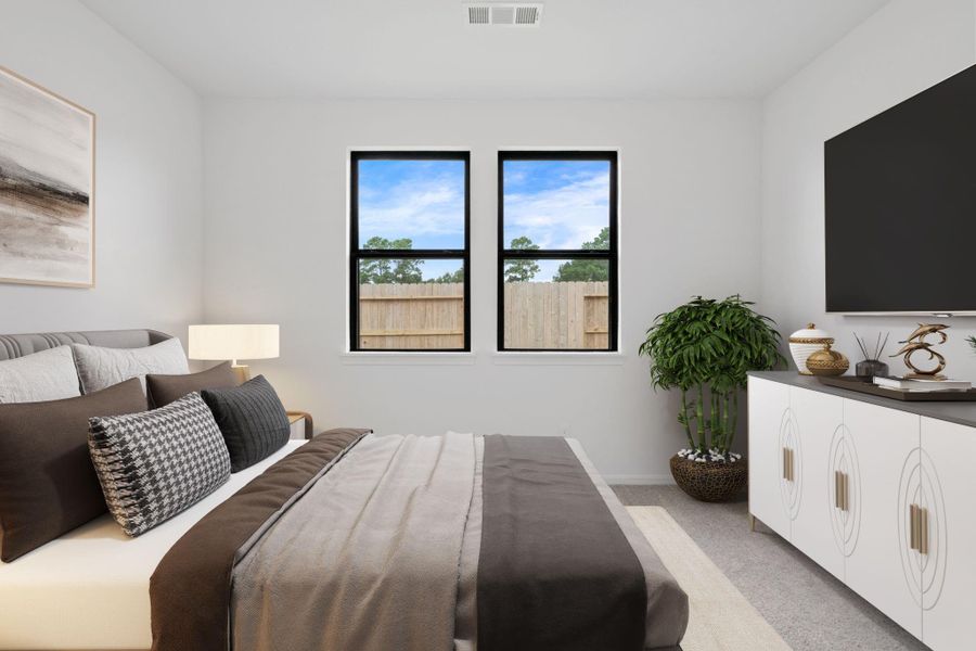 The primary bedroom is generously sized, creating a tranquil and spacious retreat that offers ample room for relaxation. Featuring plush carpet, high ceilings, fresh paint, and large windows that lets in natural lighting throughout the day.