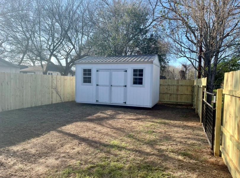 View of shed with a fenced backyard