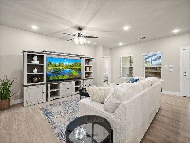 Living room with recessed lighting, light wood-type flooring, and ceiling fan Living room with recessed lighting, light wood-type flooring, and ceiling fan