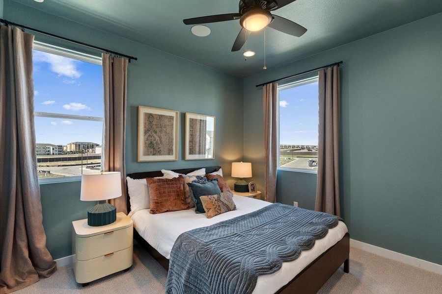 Bedroom featuring two large windows, a ceiling fan with integrated lighting, recessed lighting, and wall-to-wall carpeting