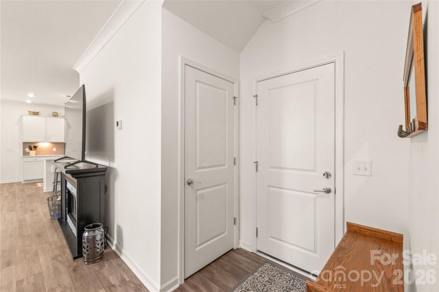 The large closet just off the garage entry uses the space under the stairs and offers a great amount of storage
