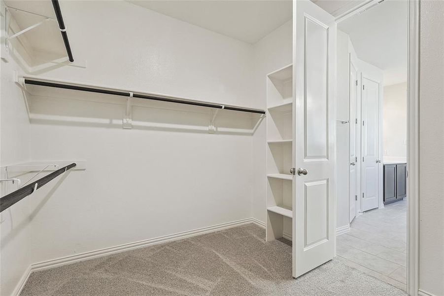 Spacious closet with light tile floors