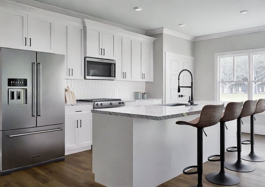 A modern kitchen featuring stainless steel appliances and sleek white cabinets.