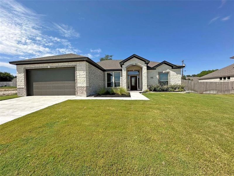 View of front of home featuring a garage, driveway, brick siding, and roof with shingles View of front of home featuring a garage, driveway, brick siding, and roof with shingles