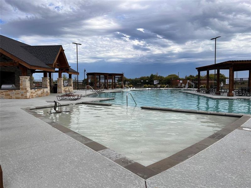 Community pool with a patio area Community pool with a patio area