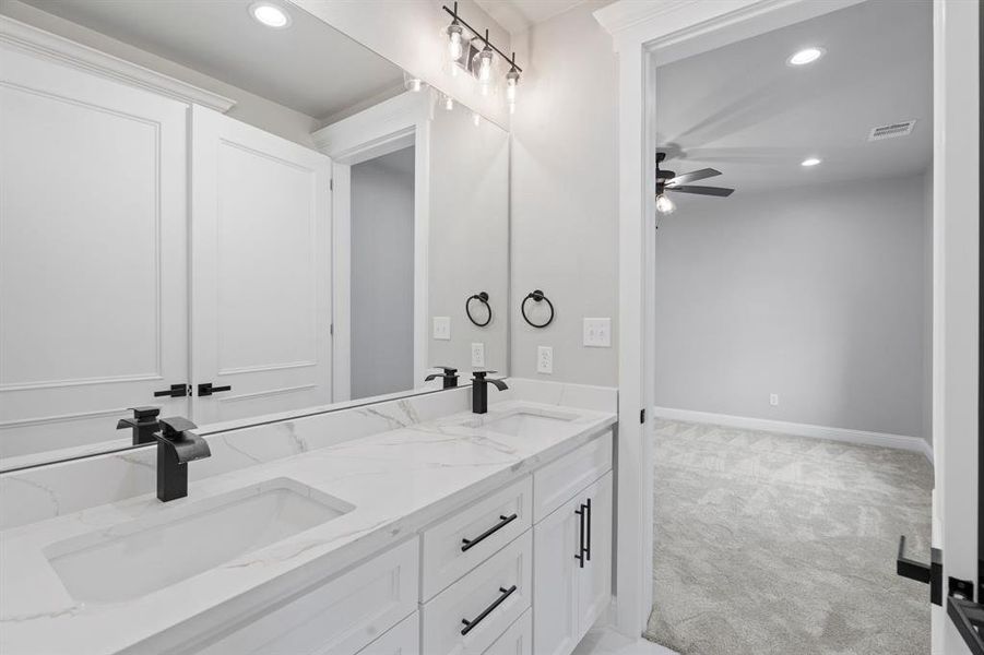 Bathroom with ceiling fan and vanity