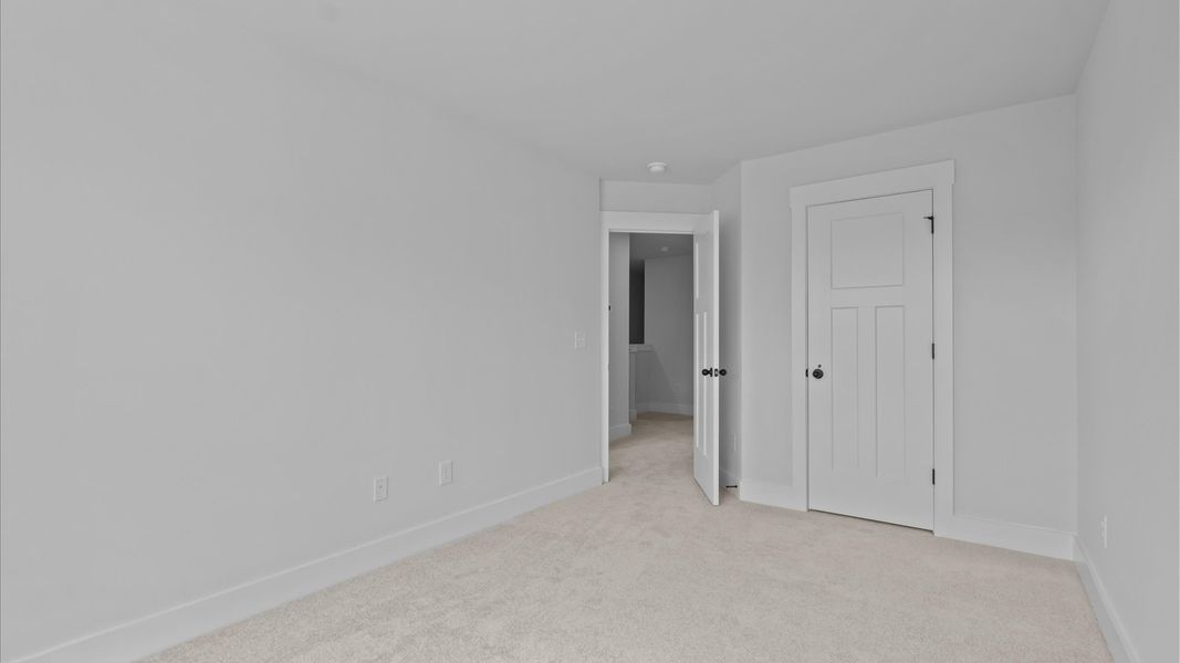 Highly functional bedroom with walk-in closet and tasteful carpet for a restful retreat Highly functional bedroom with walk-in closet and tasteful carpet for a restful retreat