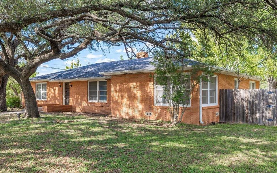 Ranch-style house featuring brick siding and a chimney