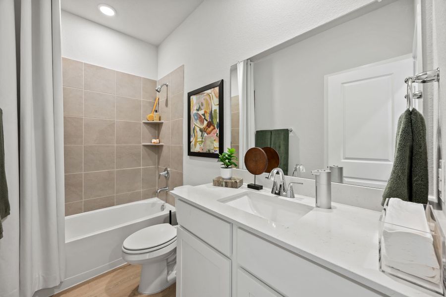 A bathroom with a tub sink and toilet. A bathroom with a tub sink and toilet.