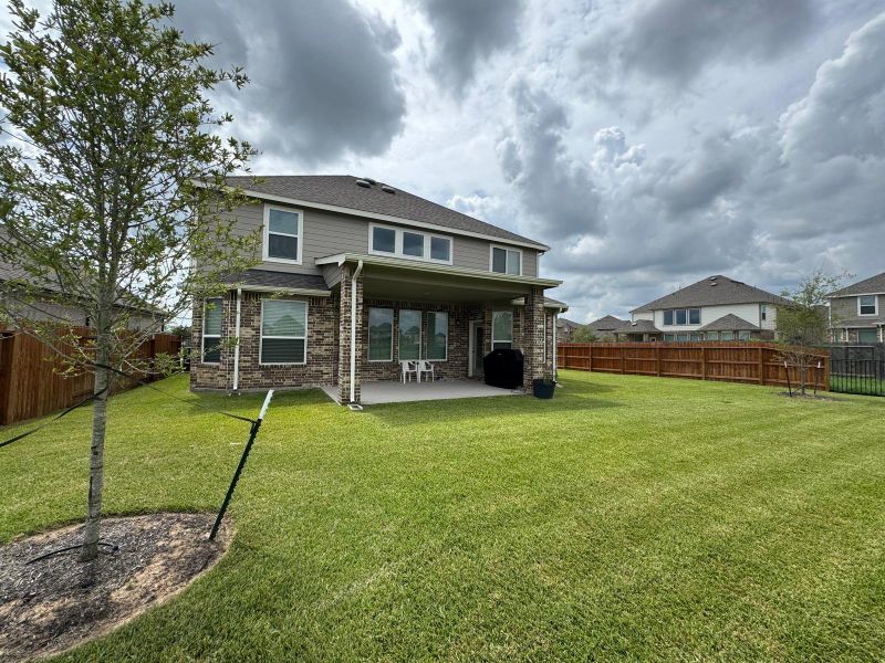 Front exterior of a new home in Rodeo Palms - The Lakes, Manvel, TX, highlighting curb appeal (Image 27). Front exterior of a new home in Rodeo Palms - The Lakes, Manvel, TX, highlighting curb appeal (Image 27).