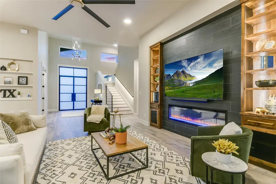 Living area featuring built in features, stairway, and recessed lighting Living area featuring built in features, stairway, and recessed lighting
