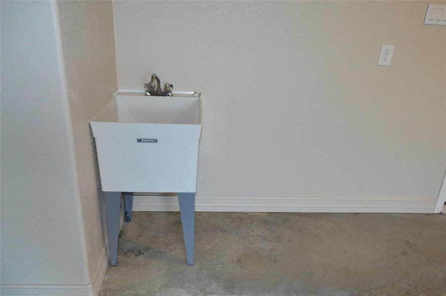 Detailed view of concrete flooring and a sink