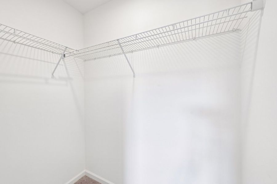 A white wall with a metal bar. A white wall with a metal bar.