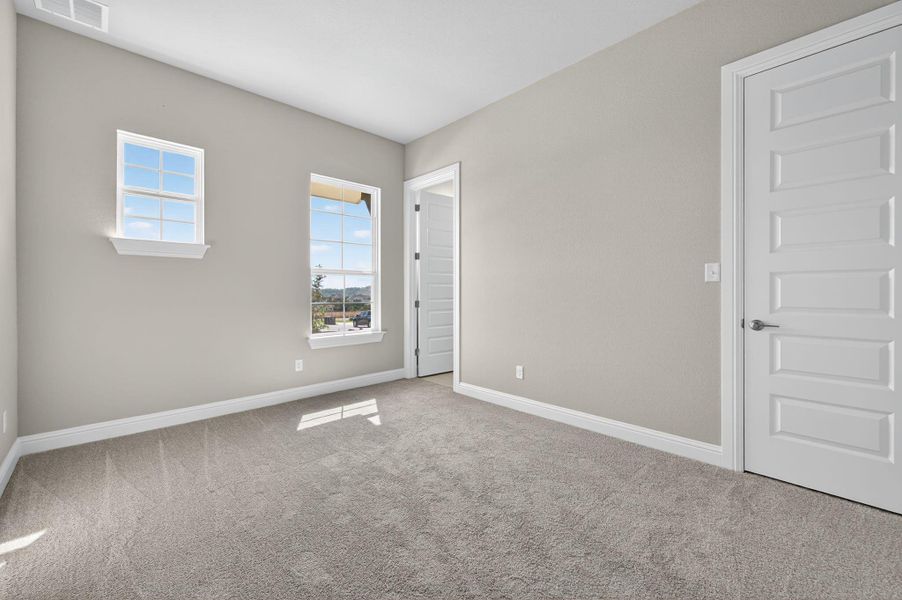 Spare room with carpet and baseboards