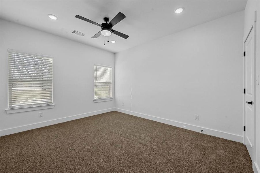 Spare room with ceiling fan and carpet floors