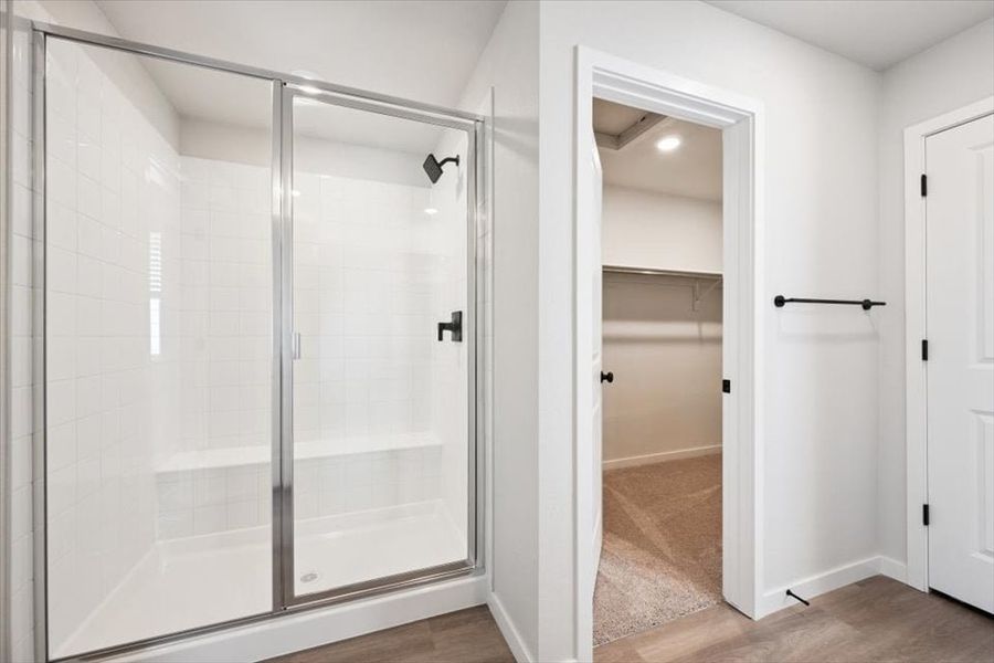 A shower with a glass door.