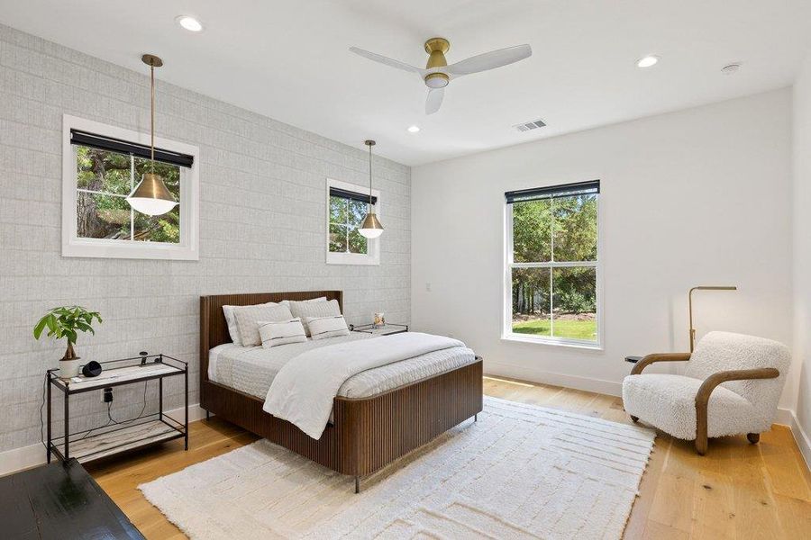 A tranquil bedroom with warm hardwood floors and abundant natural light offers a peaceful retreat. A tranquil bedroom with warm hardwood floors and abundant natural light offers a peaceful retreat.