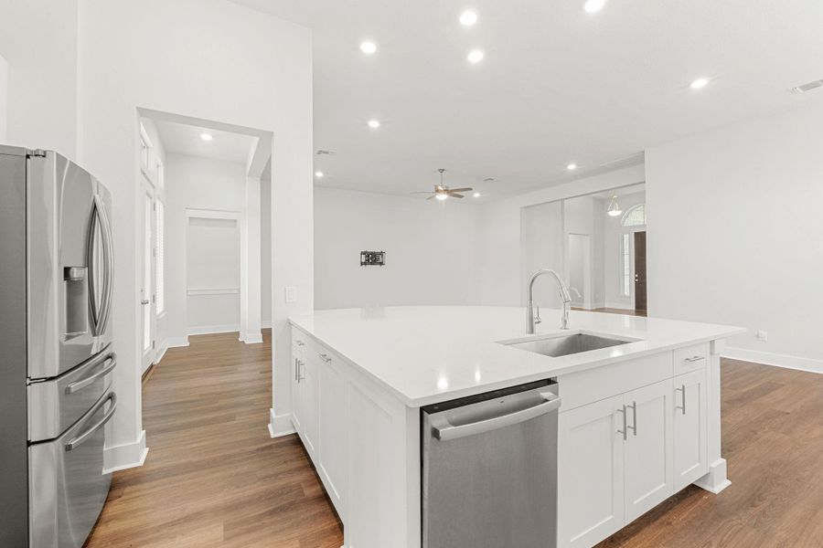 Kitchen featuring appliances with stainless steel finishes, a sink, white cabinetry, ceiling fan, and recessed lighting Kitchen featuring appliances with stainless steel finishes, a sink, white cabinetry, ceiling fan, and recessed lighting